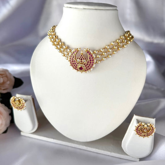 Gold necklace with ruby kemp stones , accompanied by earrings.